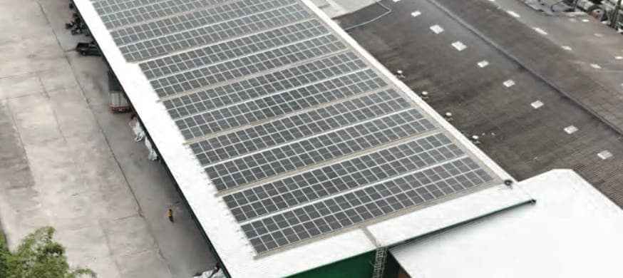 Rooftop solar panels generating clean energy on the Maruey Rubber factory roof
